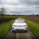White electric car parked on a rural road