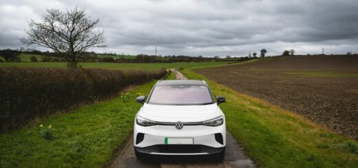 White electric car parked on a rural road